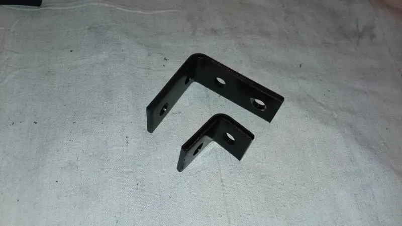 Old and new front light brackets.jpg