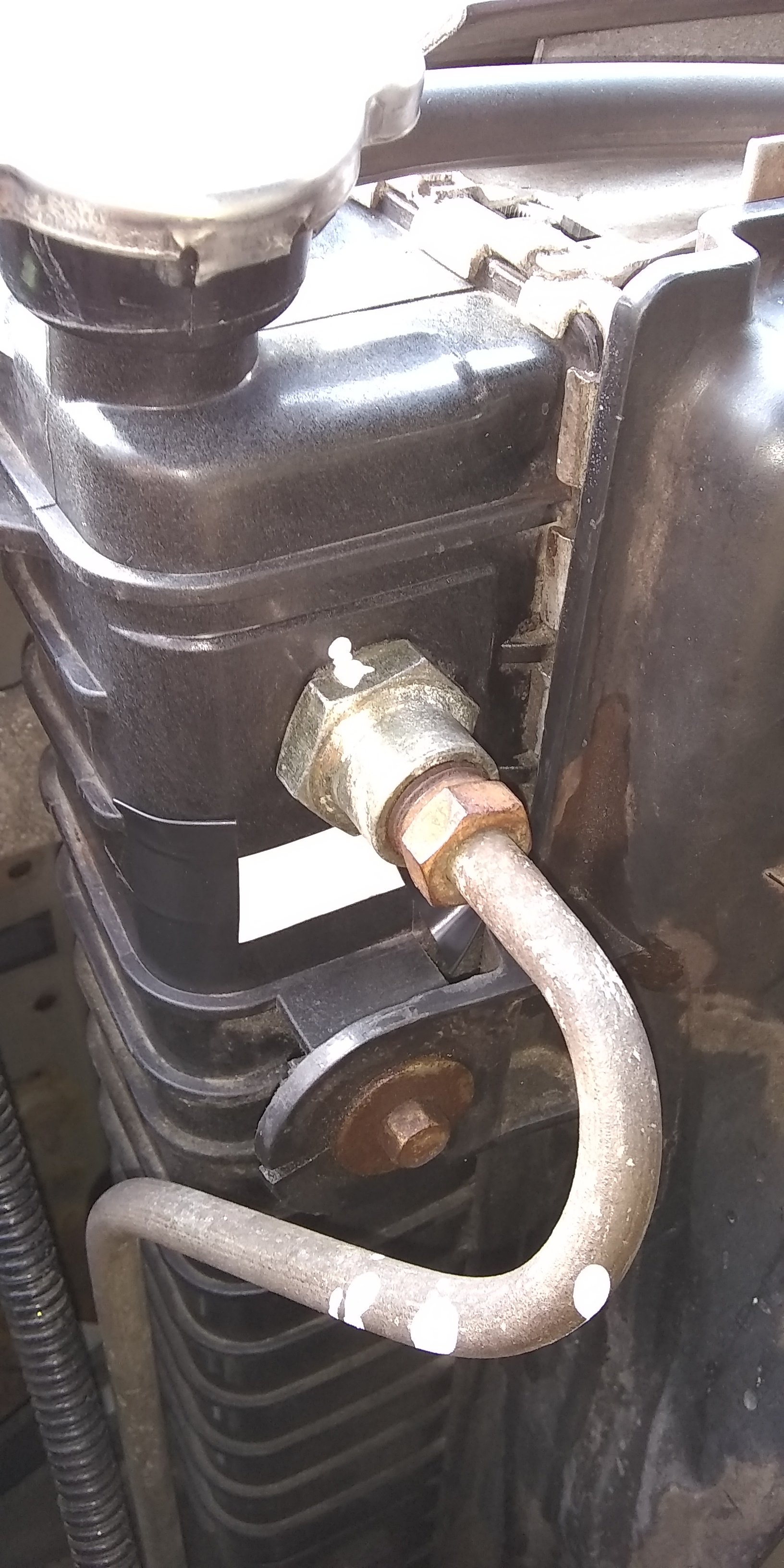 Transmission fitting into radiator, directly under radiator cap.jpg