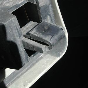 lower grille retaining mechanism