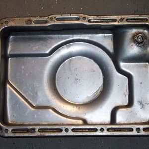 The inside of the pan with the drain plug.