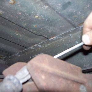 A box wrench is removing the bolt.