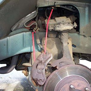 A bungee stretch cord is holding the caliper.