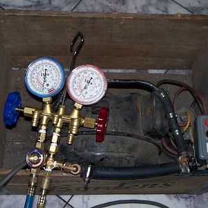 An old compressor is used as a vacuum pump.