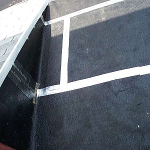 Torchdown rubberized roofing with seam tape.