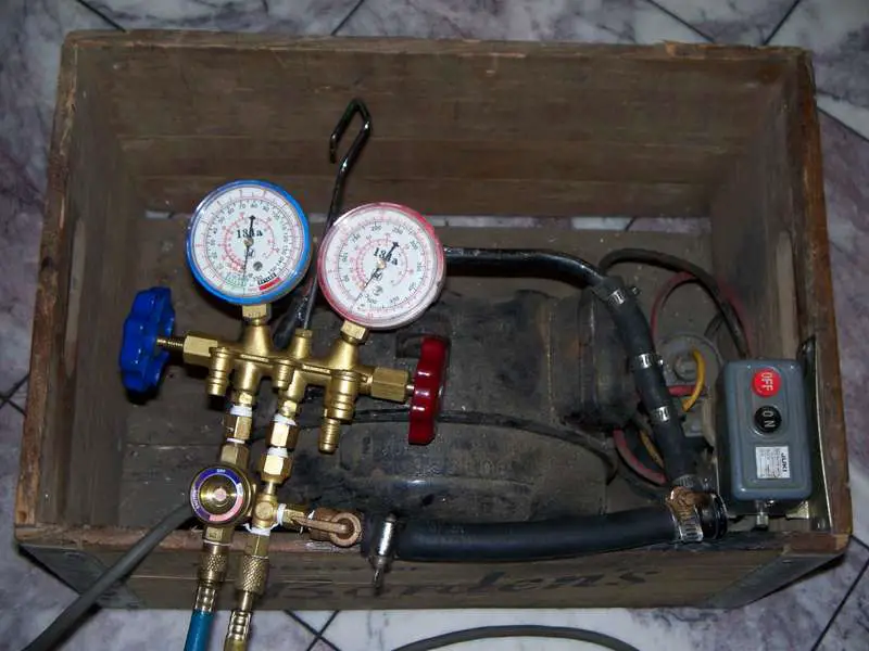 An old compressor is used as a vacuum pump.