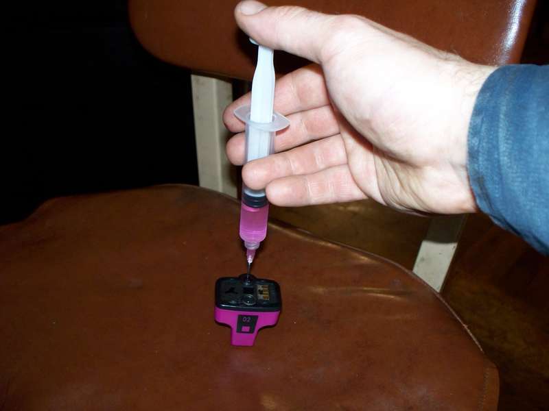 Injecting the ink into the cartridge.