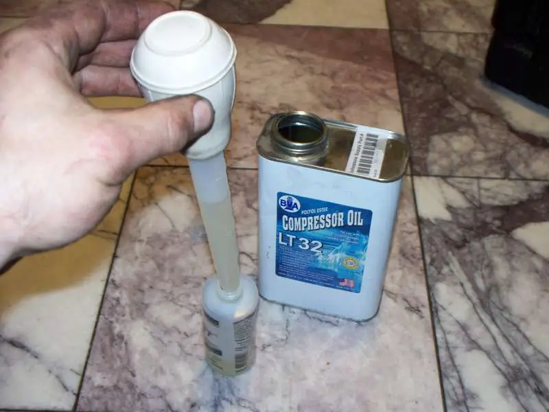 Refilling the squeeze bottle with oil.