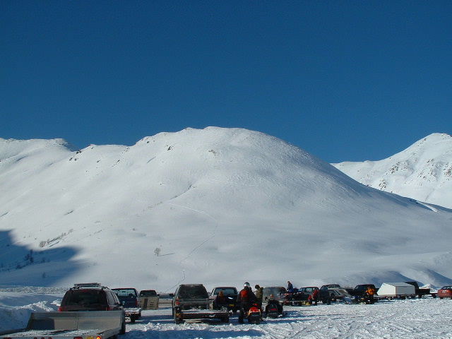 See the skiers walking up the face