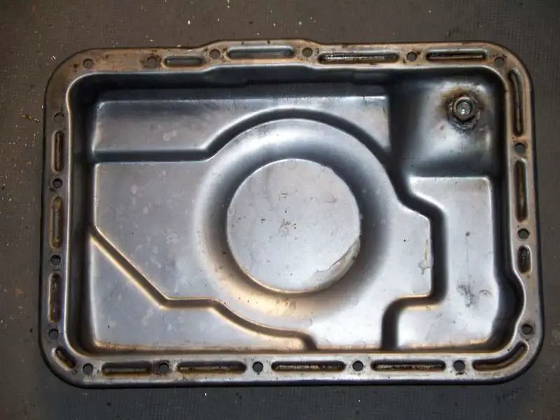 The inside of the pan with the drain plug.