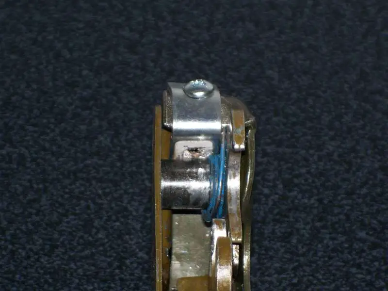 The L bracket keeps the spring in place.